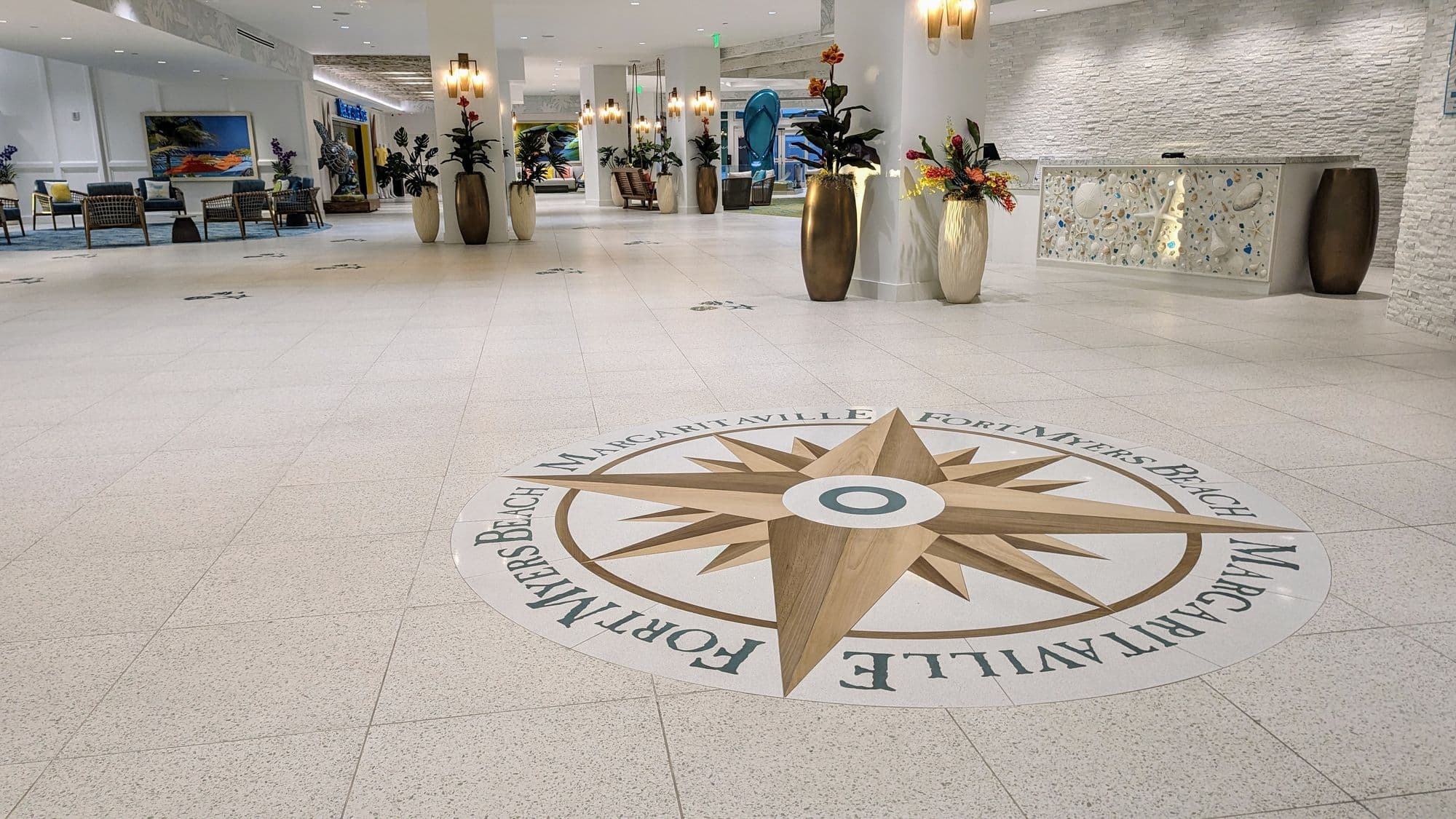Resort lobby terrazzo floor with a custom compass-rose medallion reading Margaritaville Fort Myers Beach